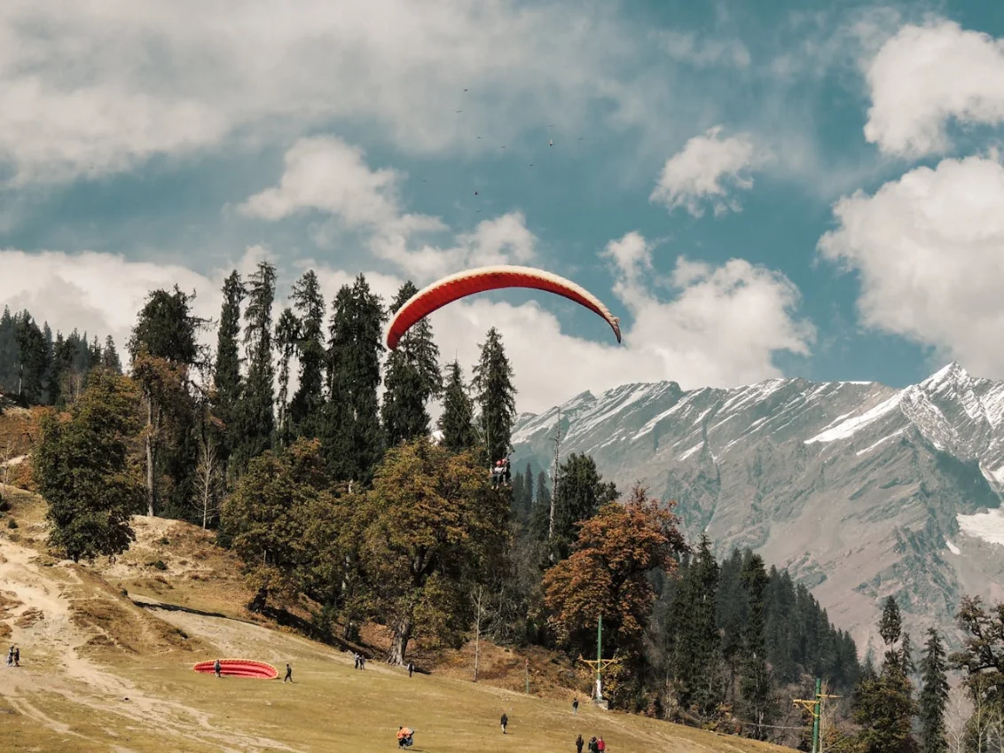 Tandem over Solang — 20-minute glide, certified Himalayan pilots.