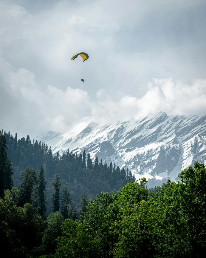 Wings over Solang — paraglider above the valley
